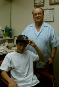 middle-aged barber with teenaged client in 2013